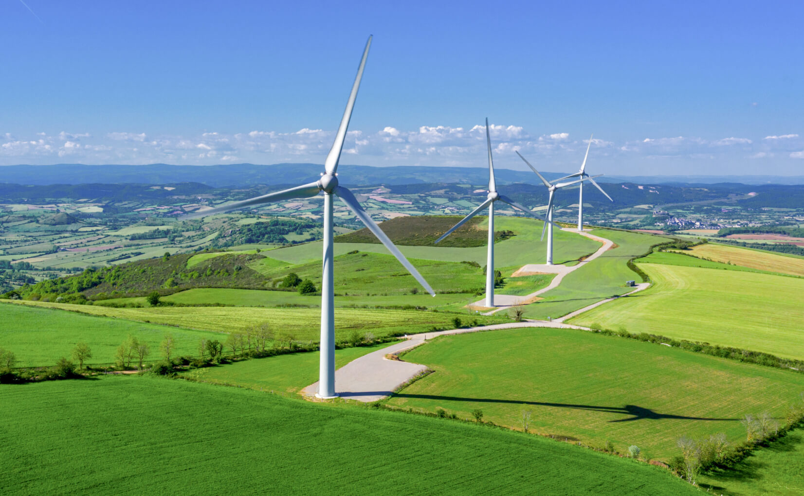 Wind energy windmills in green fields.